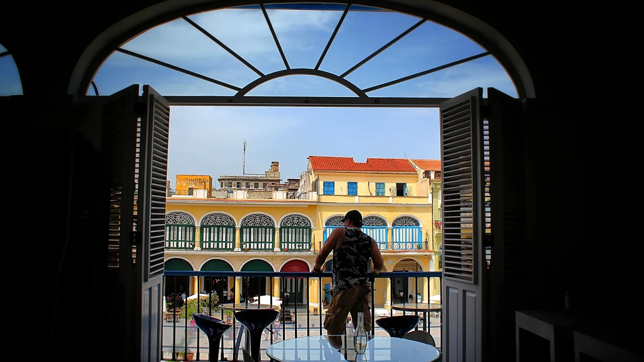 View across Plaza de Armas, Havana, framed by an open balcony